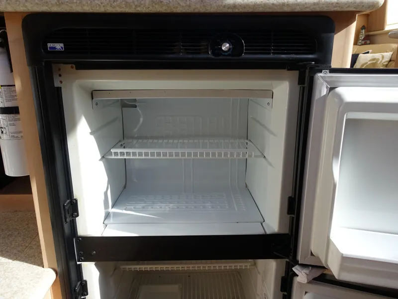 Slide: The Image of Empty refrigerator inside 2000 Carver 406 Aft Cabin Motor Yacht. - 12