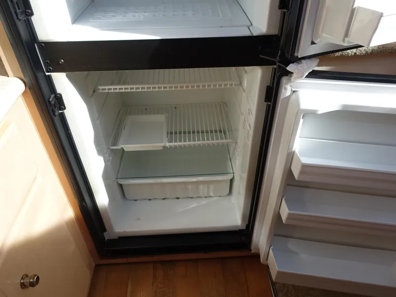 Slide: The Image of Open refrigerator in 2000 Carver 406 Aft Cabin Motor Yacht kitchen area. - 13