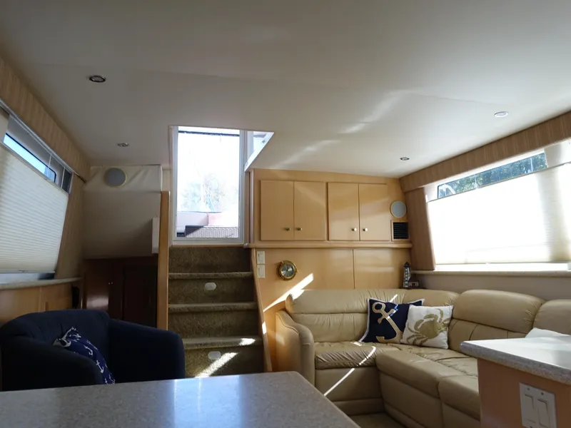 Slide: The Image of Interior of 2000 Carver 406 Aft Cabin Motor Yacht, featuring cozy seating and natural light. - 15