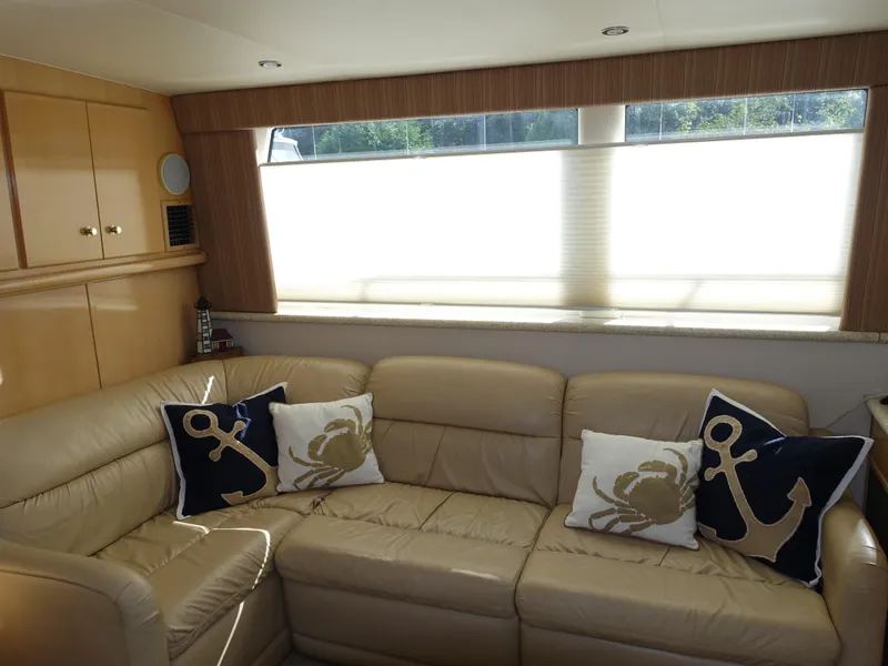 Slide: The Image of Luxurious interior of 2000 Carver 406 Aft Cabin Motor Yacht with nautical-themed pillows. - 23