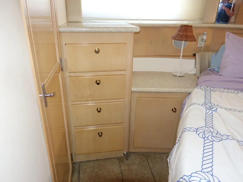 Slide: The Image of Interior of 2000 Carver 406 Aft Cabin Motor Yacht with wooden drawers and bed. - 30