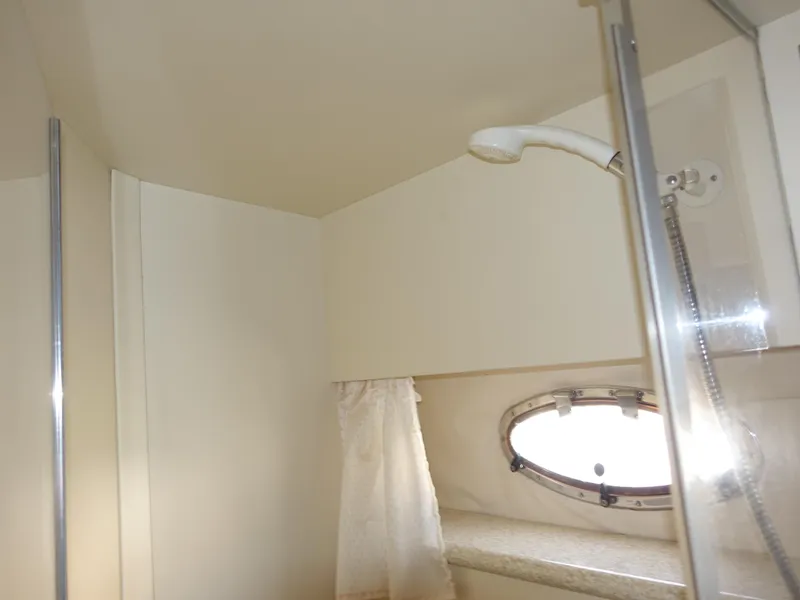Slide: The Image of Bathroom interior of 2000 Carver 406 Aft Cabin Motor Yacht with shower and porthole. - 33