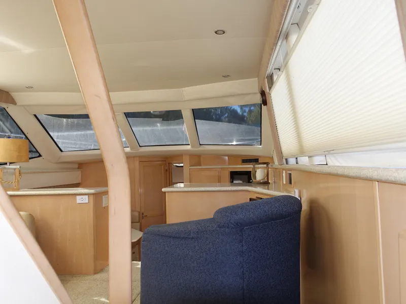 Slide: The Image of Interior of 2000 Carver 406 Aft Cabin Motor Yacht with modern furnishings and large windows. - 36