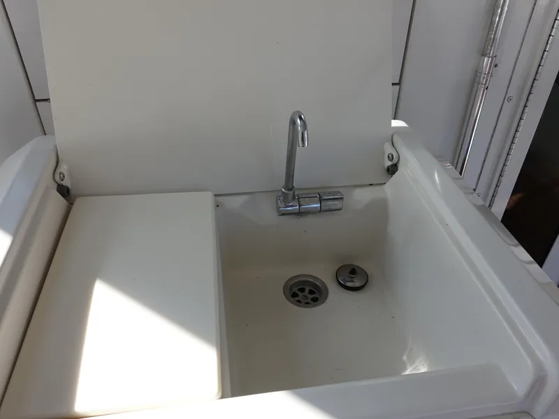 Slide: The Image of Carver 406 Aft Cabin Motor Yacht 2000 sink with faucet in white finish. - 39