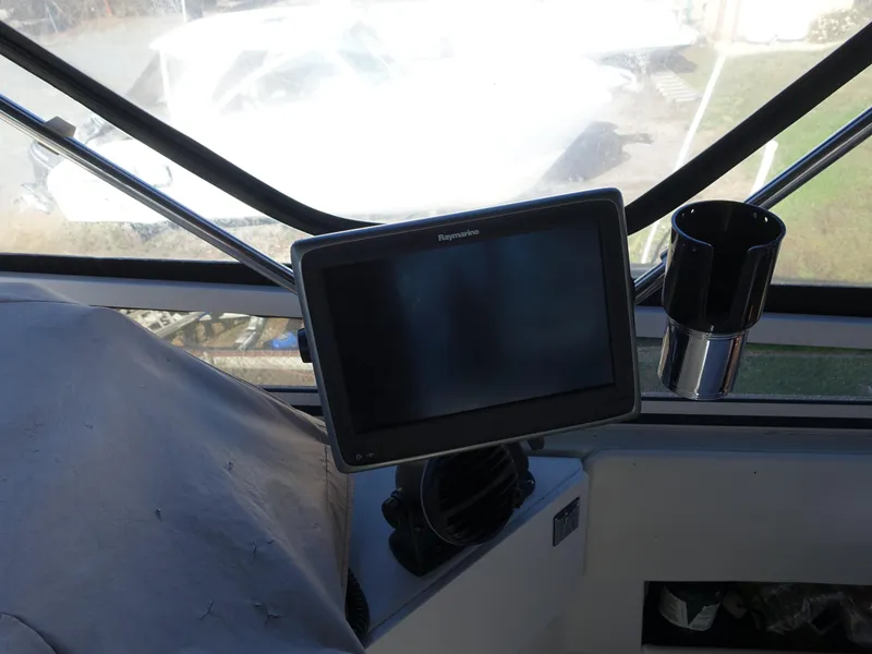 Slide: The Image of Carver 406 Aft Cabin Motor Yacht 2000 helm with Raymarine display and cup holder. - 46
