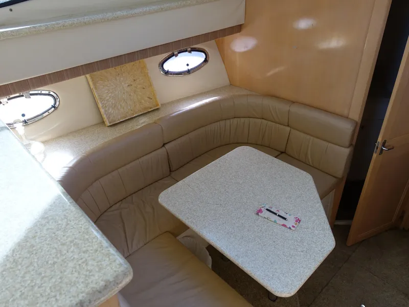 Slide: The Image of Interior of 2000 Carver 406 Aft Cabin Motor Yacht with beige seating and table. - 10