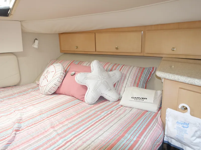 Slide: The Image of Cozy bedroom in 2000 Carver 406 Aft Cabin Motor Yacht with nautical-themed decor. - 17