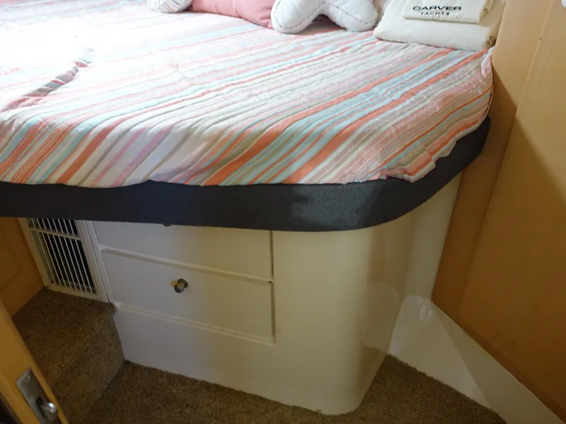 Slide: The Image of Cozy cabin interior of 2000 Carver 406 Aft Cabin Motor Yacht with striped bedding. - 19