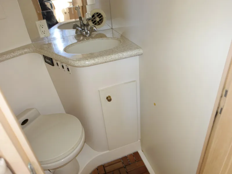 Slide: The Image of Compact bathroom in 2000 Carver 406 Aft Cabin Motor Yacht with sink and toilet. - 21