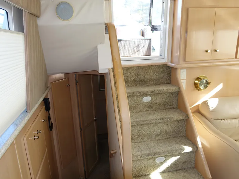 Slide: The Image of Interior of 2000 Carver 406 Aft Cabin Motor Yacht with carpeted stairs and wooden cabinetry. - 24