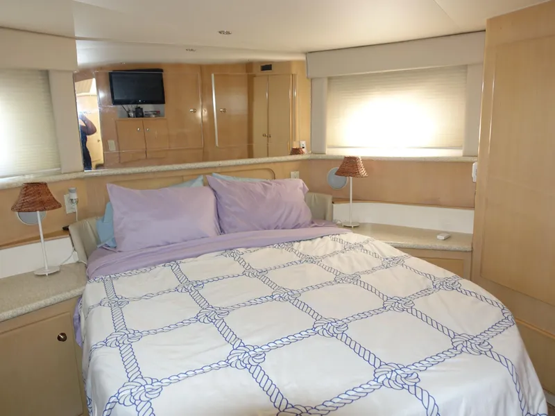 Slide: The Image of Interior of 2000 Carver 406 Aft Cabin Motor Yacht bedroom with cozy bed and modern decor. - 26