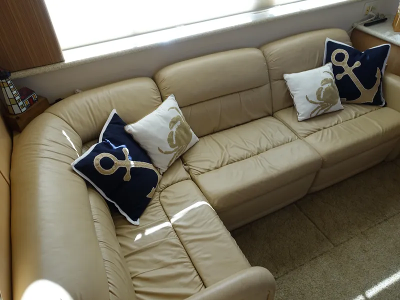Slide: The Image of Beige leather sofa with nautical-themed pillows in Carver 406 Aft Cabin Motor Yacht, 2000. - 3