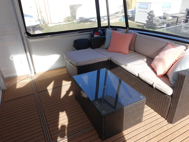 Slide: The Image of 2000 Carver 406 Aft Cabin Motor Yacht interior with wicker seating and glass table. - 37