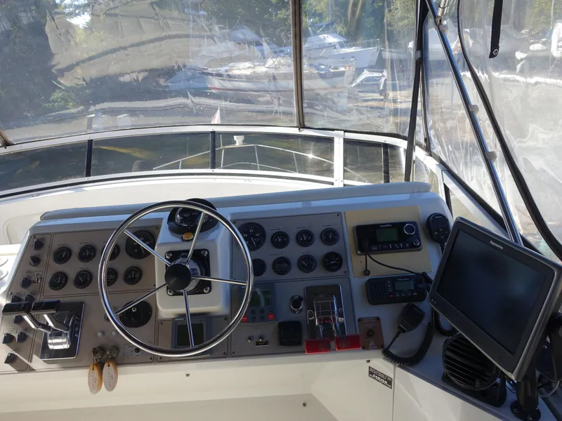 Slide: The Image of Helm of 2000 Carver 406 Aft Cabin Motor Yacht with steering wheel and navigation controls. - 43