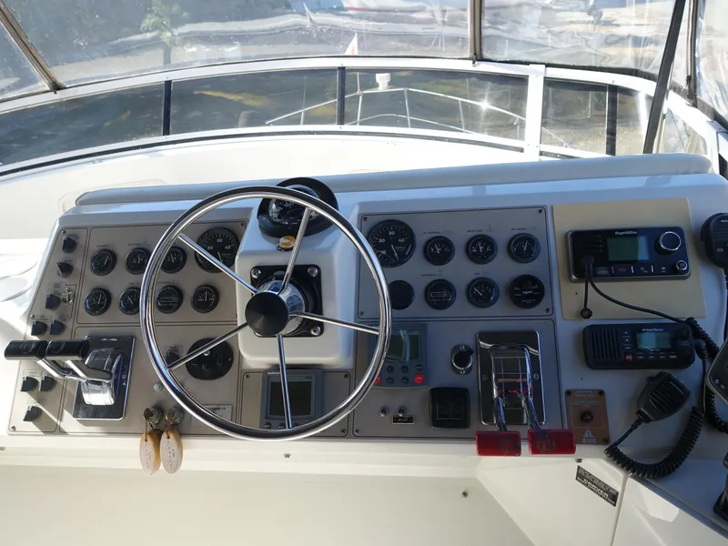 Slide: The Image of Control panel of 2000 Carver 406 Aft Cabin Motor Yacht with steering wheel and gauges. - 44