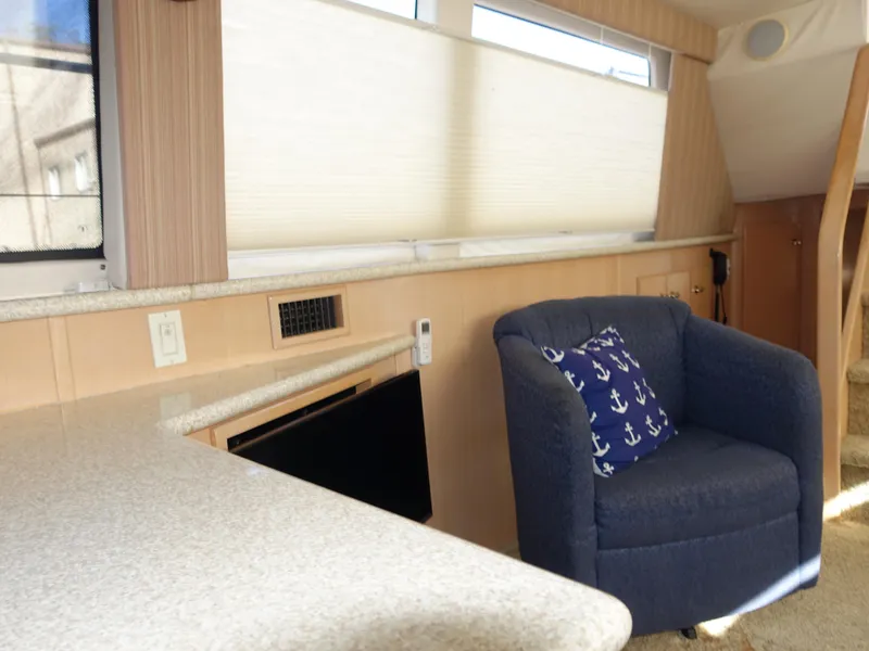 Slide: The Image of Interior of 2000 Carver 406 Aft Cabin Motor Yacht with blue armchair and anchor pillow. - 5