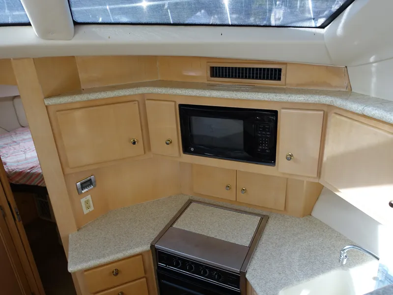 Slide: The Image of Interior kitchen of 2000 Carver 406 Aft Cabin Motor Yacht with microwave and stove. - 7