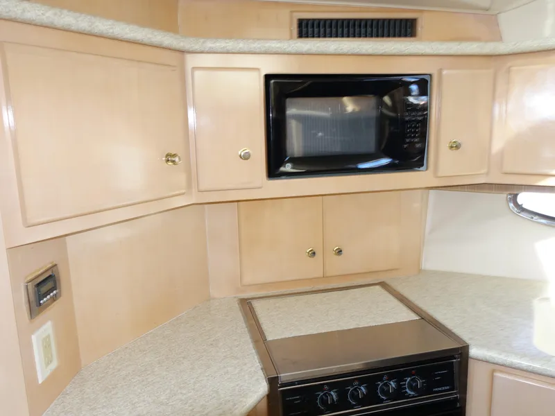 Slide: The Image of 2000 Carver 406 Aft Cabin Motor Yacht kitchen with microwave and stove. - 8