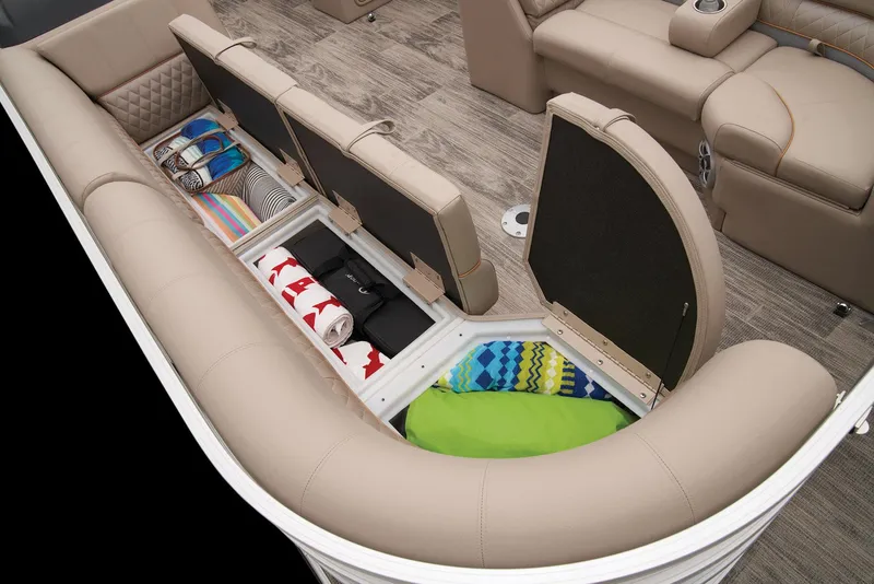 Slide: The Image of 2024 Ranger Reata 220C boat interior with open storage compartments and colorful towels. - 15