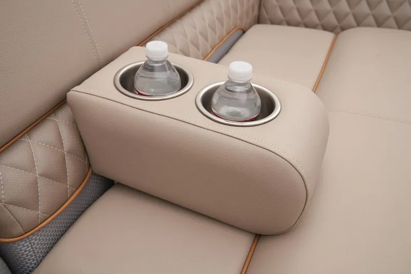 Slide: The Image of 2024 Ranger Reata 220C interior with beige leather seats and dual cup holders. - 17