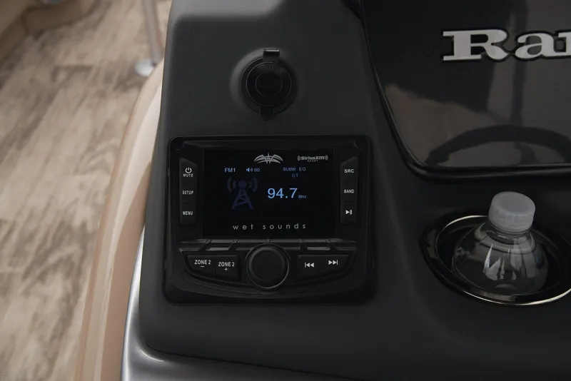 Slide: The Image of 2024 Ranger Reata 220C dashboard with radio display and cup holder. - 34