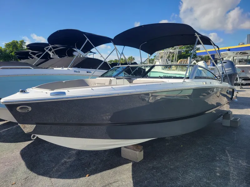 The Image of 2024 Four Winns H1 OB boat with black canopy on display. - 0