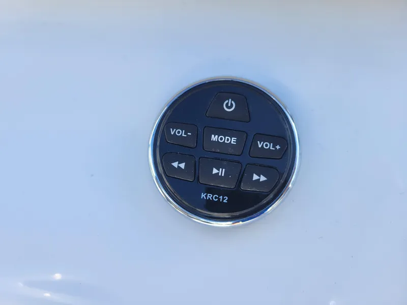 Slide: The Image of 2024 Four Winns H1 OB boat control panel with volume and mode buttons. - 11