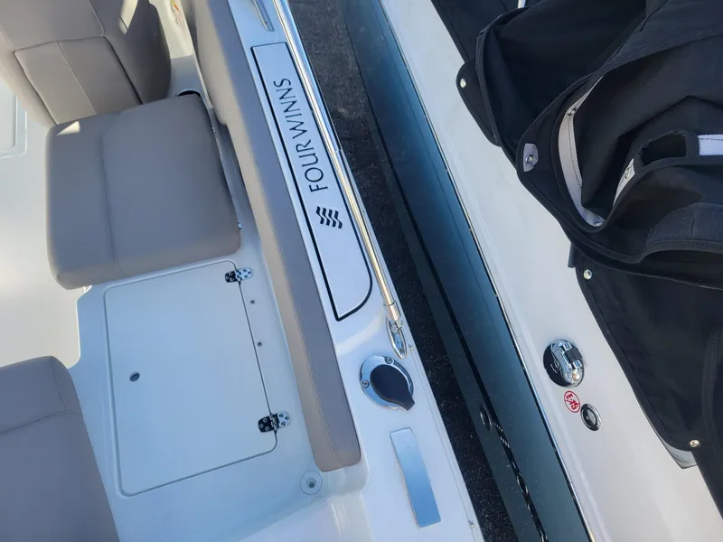 Slide: The Image of 2024 Four Winns H1 OB boat interior with seating and storage compartments. - 12