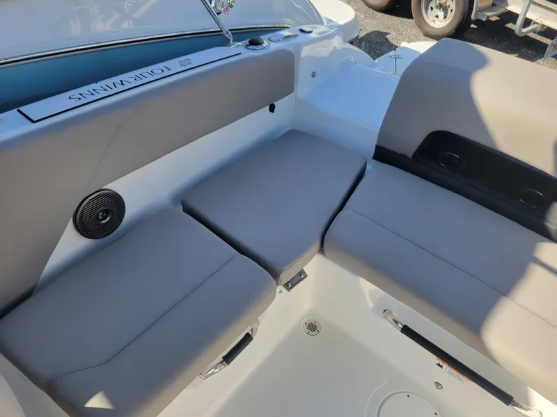 Slide: The Image of 2024 Four Winns H1 OB boat interior seating area with gray cushions. - 17