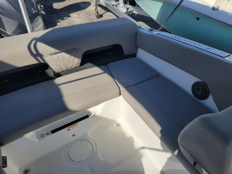Slide: The Image of 2024 Four Winns H1 OB boat interior with gray cushioned seating. - 18