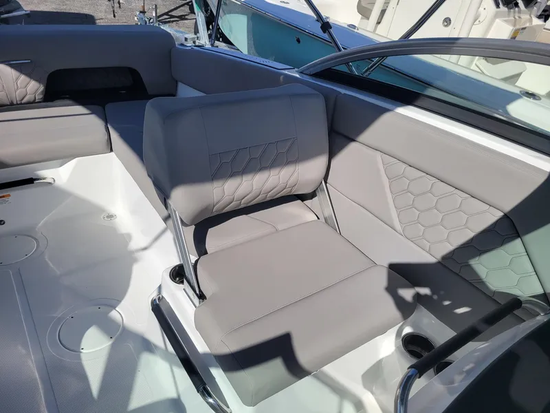 Slide: The Image of 2024 Four Winns H1 OB boat interior with gray seating and modern design. - 19