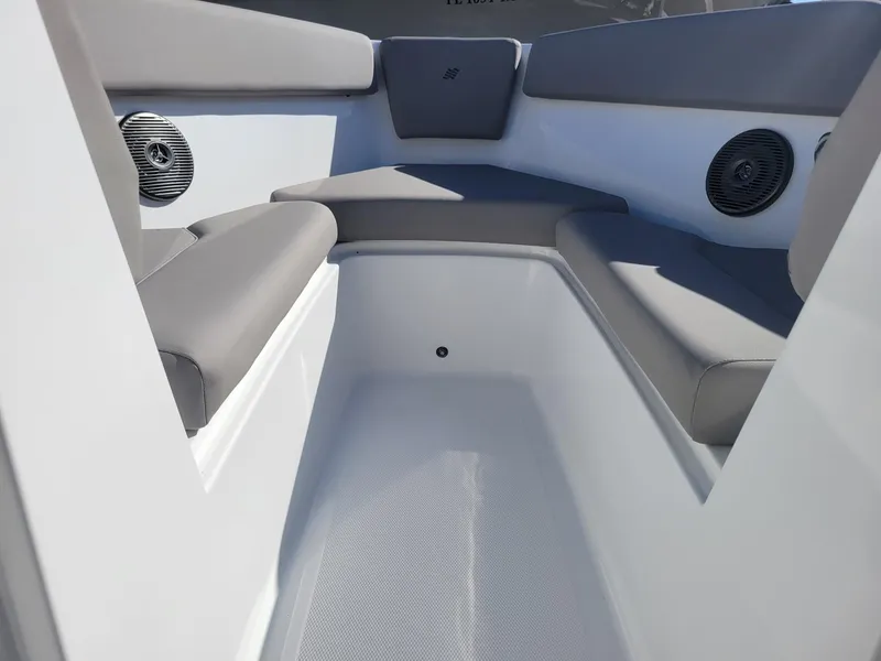 Slide: The Image of 2024 Four Winns H1 OB boat interior with cushioned seating and built-in speakers. - 23
