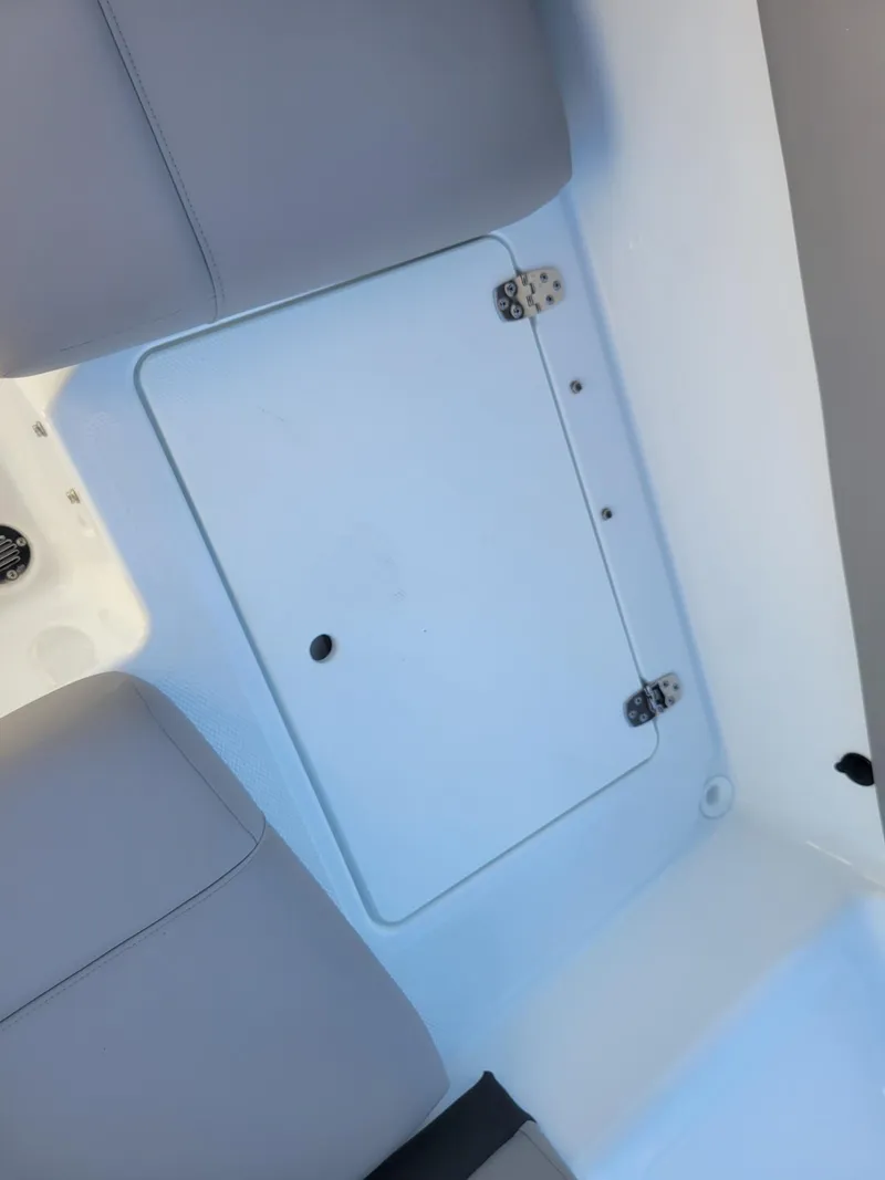 Slide: The Image of 2024 Four Winns H1 OB boat storage compartment with cushioned seating. - 28