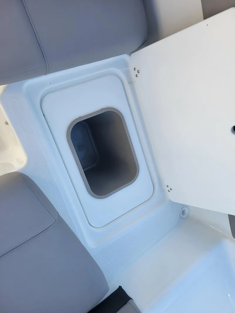 Slide: The Image of 2024 Four Winns H1 OB boat storage compartment with open lid. - 29