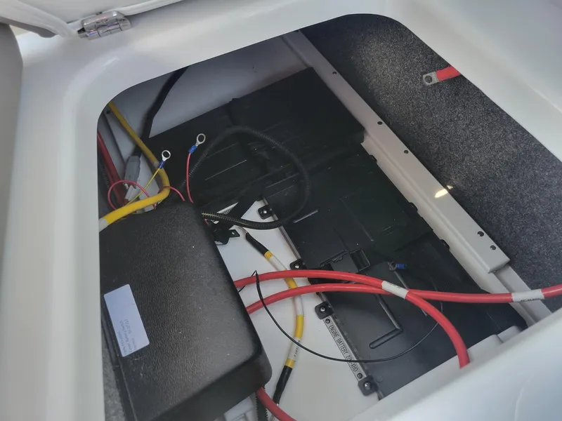 Slide: The Image of 2024 Four Winns H1 OB boat battery compartment with wiring. - 35