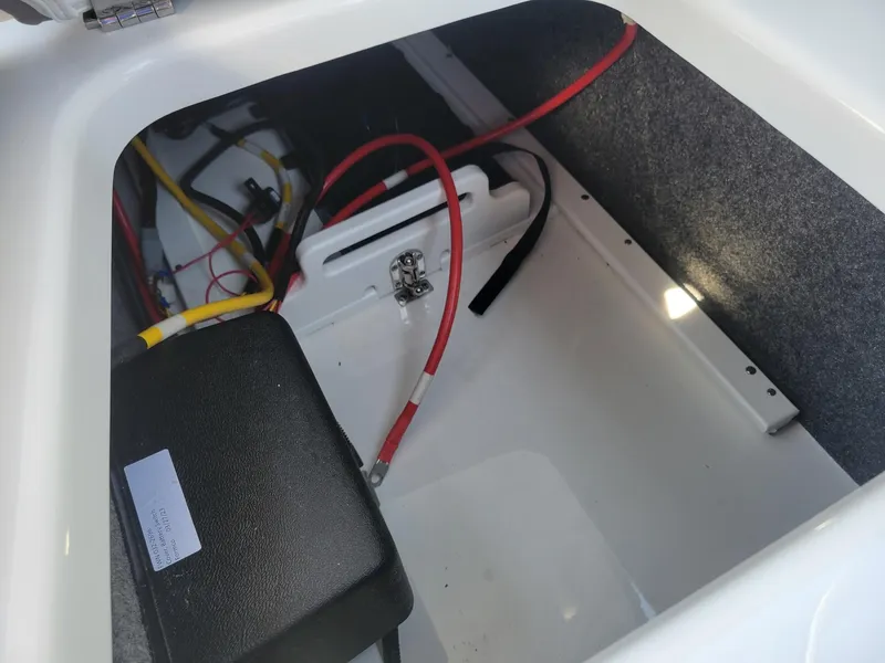 Slide: The Image of 2024 Four Winns H1 OB boat battery compartment with wiring. - 36