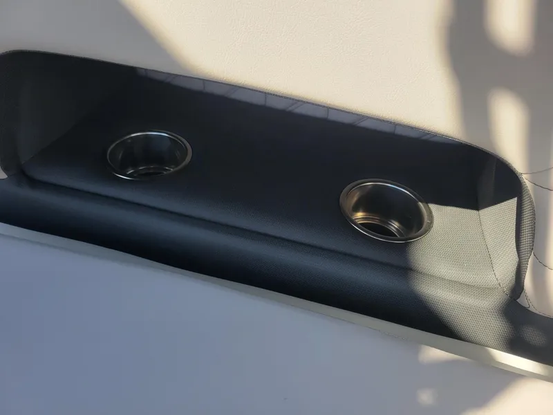 Slide: The Image of 2024 Four Winns H1 OB boat interior with dual cup holders. - 38