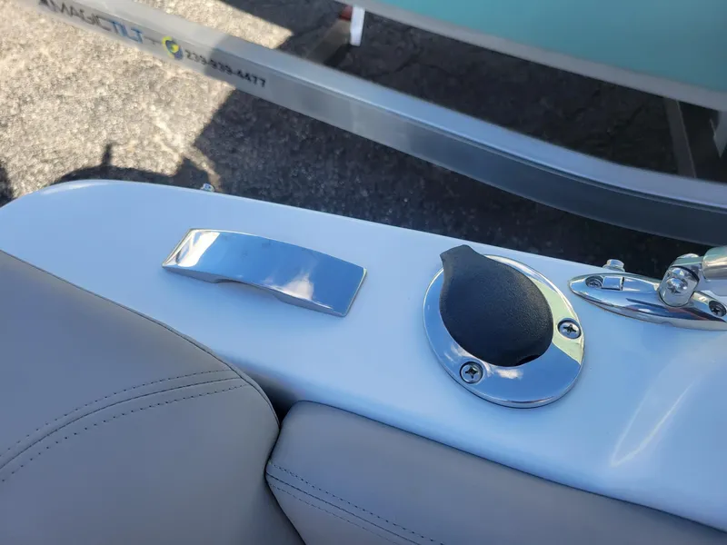 Slide: The Image of 2024 Four Winns H1 OB boat interior detail with chrome handle and cap. - 39