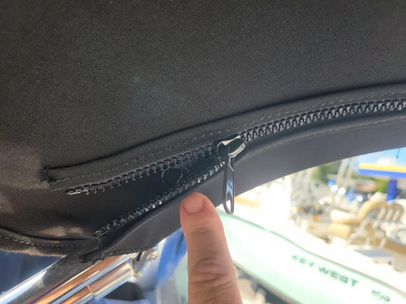 Slide: The Image of Close-up of a zipper on a 2024 Four Winns H1 OB boat canopy. - 42