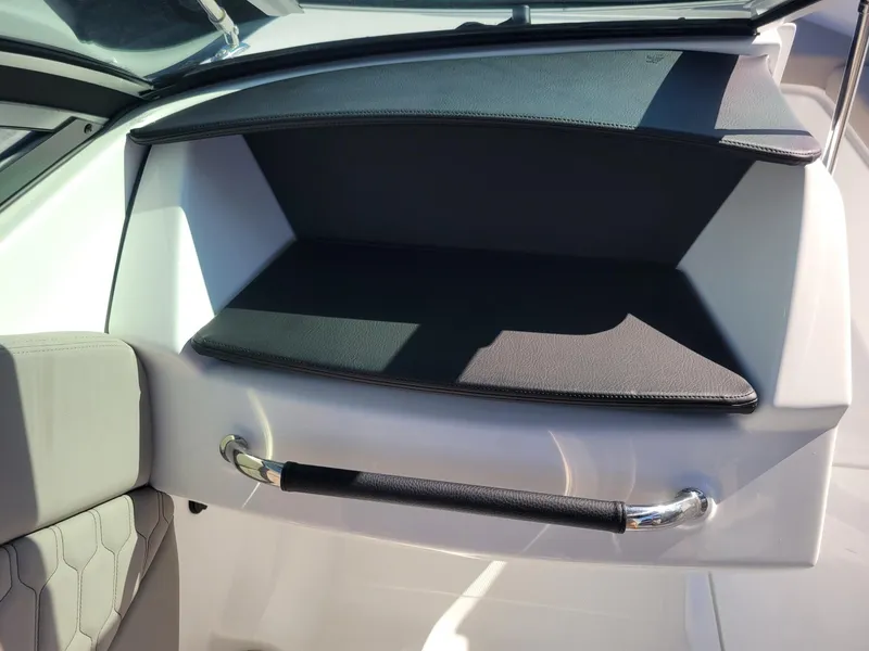 Slide: The Image of 2024 Four Winns H1 OB boat interior storage compartment with handle. - 43