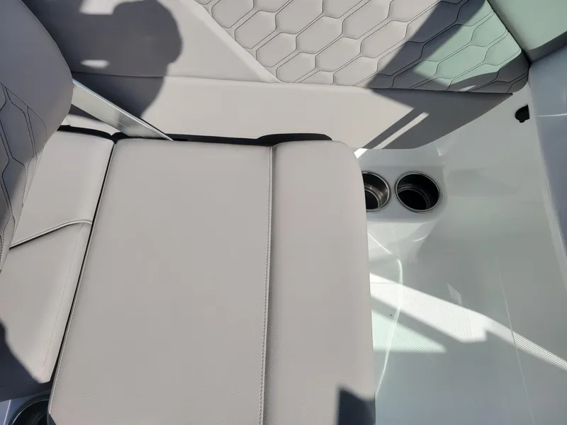 Slide: The Image of 2024 Four Winns H1 OB boat interior with gray seating and cup holders. - 47