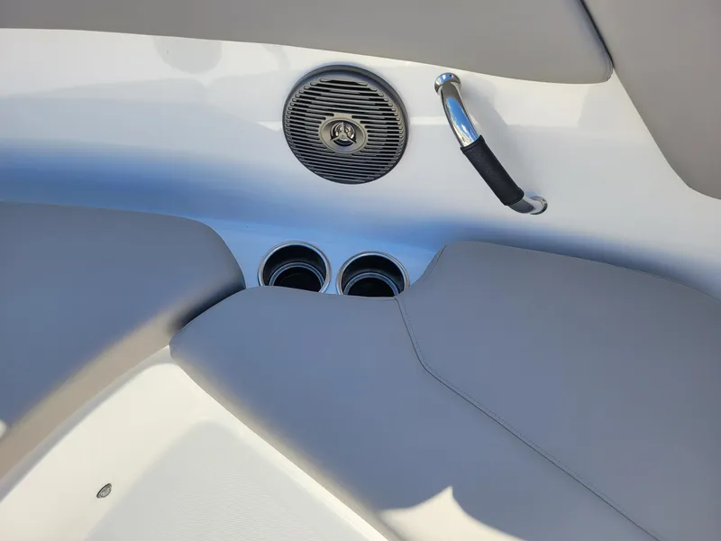 Slide: The Image of 2024 Four Winns H1 OB boat interior with cup holders and speaker. - 49