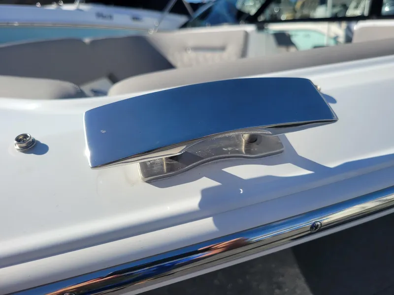 Slide: The Image of 2024 Four Winns H1 OB boat cleat and interior seating detail. - 8