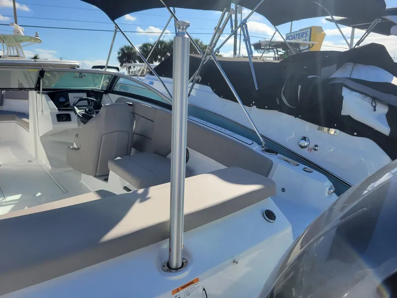 Slide: The Image of 2024 Four Winns H1 OB boat interior with seating and steering console. - 9