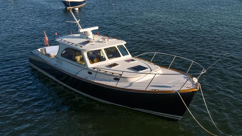 The Image of 2005 Hinckley Talaria 40 yacht anchored in a scenic harbor. - 0