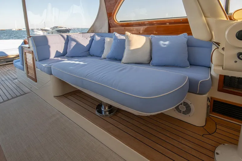 Slide: The Image of Helm of 2005 Hinckley Talaria 40 yacht with luxurious seating and navigation controls. - 11