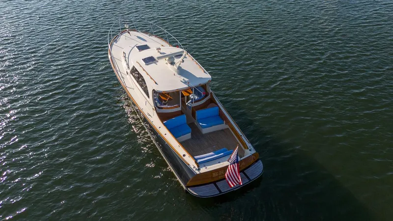 Slide: The Image of Luxurious interior of 2005 Hinckley Talaria 40 yacht with elegant wood and blue seating. - 2