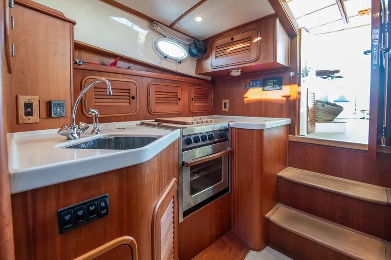 Slide: The Image of Luxurious 2005 Hinckley Talaria 40 yacht interior with blue cushioned seating. - 20