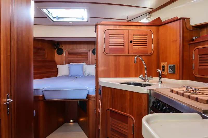 Slide: The Image of Interior of 2005 Hinckley Talaria 40 yacht with wood finish and compact kitchen. - 27