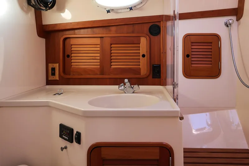 Slide: The Image of 2005 Hinckley Talaria 40 yacht bathroom with wooden accents and modern fixtures. - 33